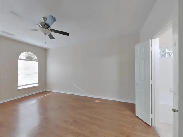 an empty room with windows and closet