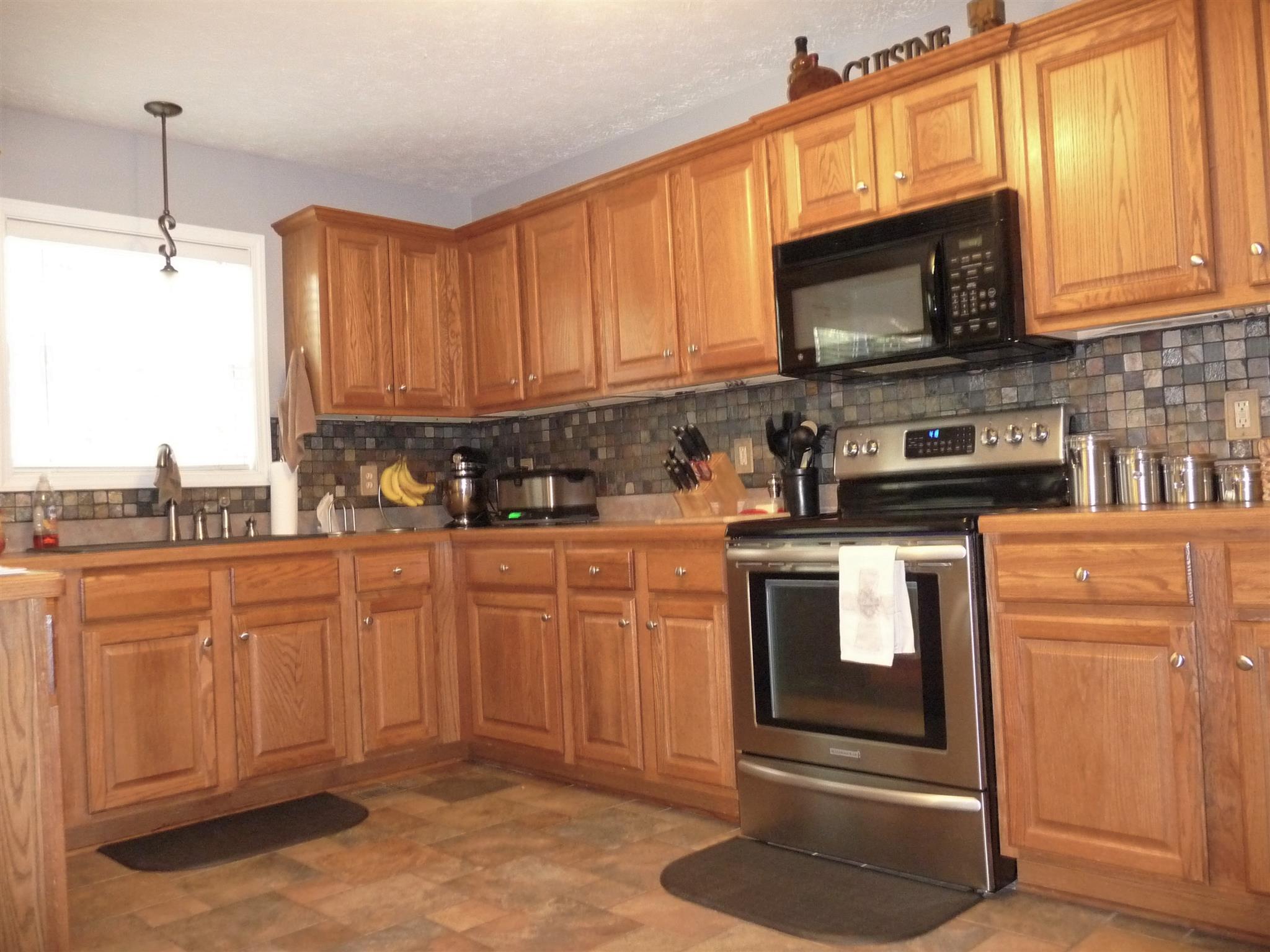 198 Wilkinson Road Cottontown, TN 37048 - Photo 9 of 23 a kitchen with stainless steel appliances granite countertop a stove microwave and refrigerator