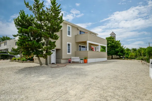 an aerial view of a house with a yard and sitting area