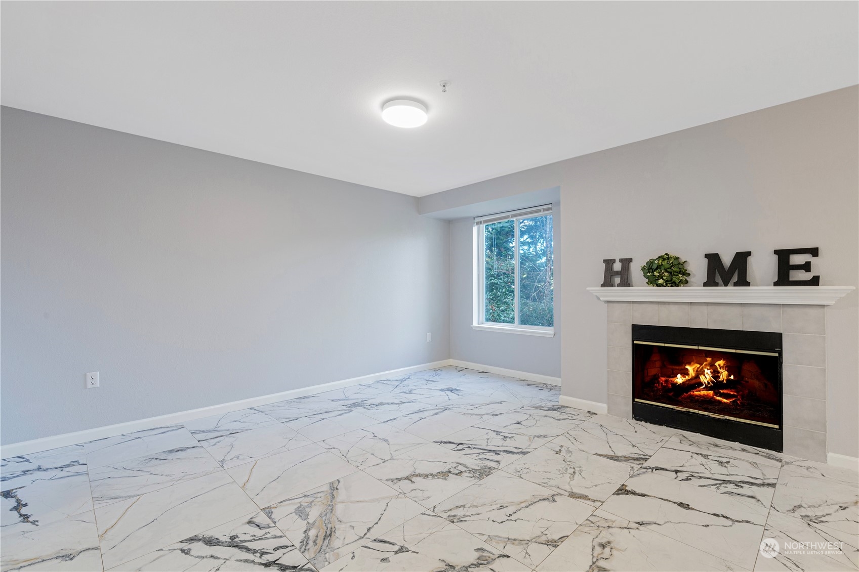 11002 Southeast Petrovitsky Road, Unit F202 Renton, WA 98055 - Photo 4 of 20 a living room with a fireplace