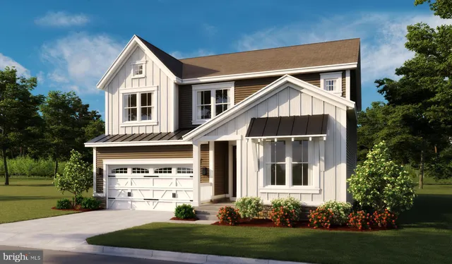 a front view of a house with a yard and trees