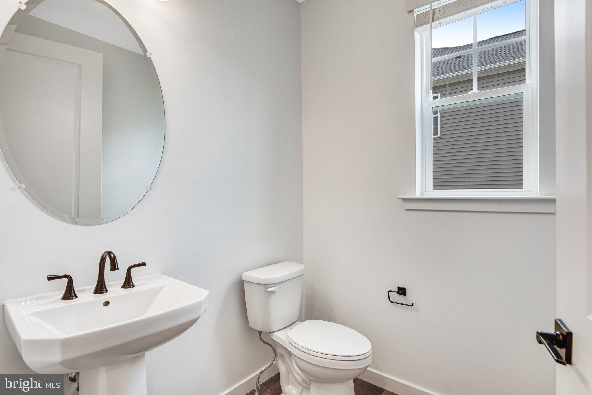 2071 Springvale Drive Bealeton, VA 22712 - Photo 12 of 64 a white toilet sitting next to a bathroom sink