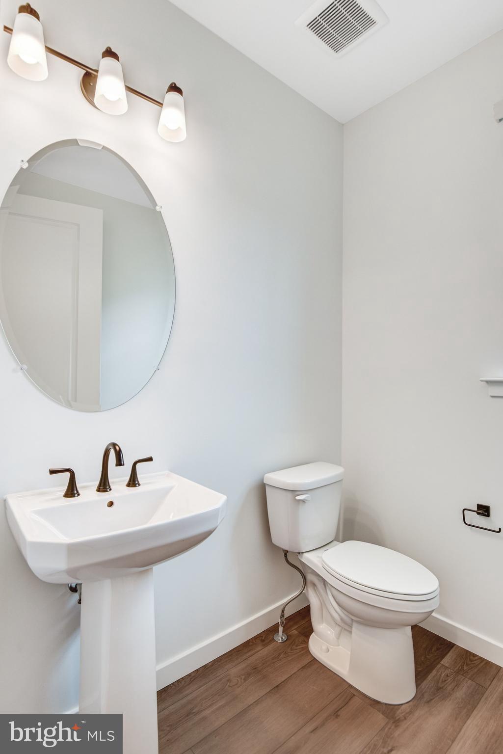 2071 Springvale Drive Bealeton, VA 22712 - Photo 13 of 64 a bathroom with a toilet a sink and mirror
