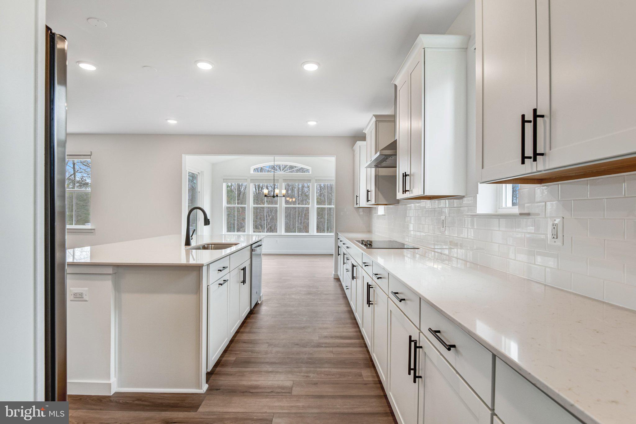2071 Springvale Drive Bealeton, VA 22712 - Photo 17 of 64 a large kitchen with stainless steel appliances lots of counter space and wooden floor