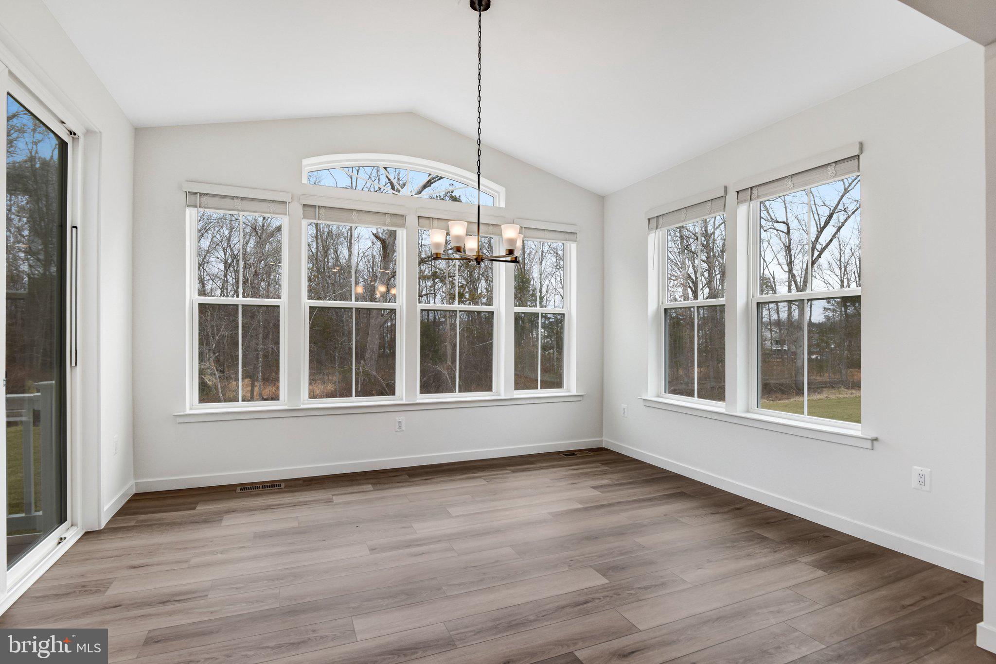 2071 Springvale Drive Bealeton, VA 22712 - Photo 21 of 64 a view of an empty room with wooden floor and a window