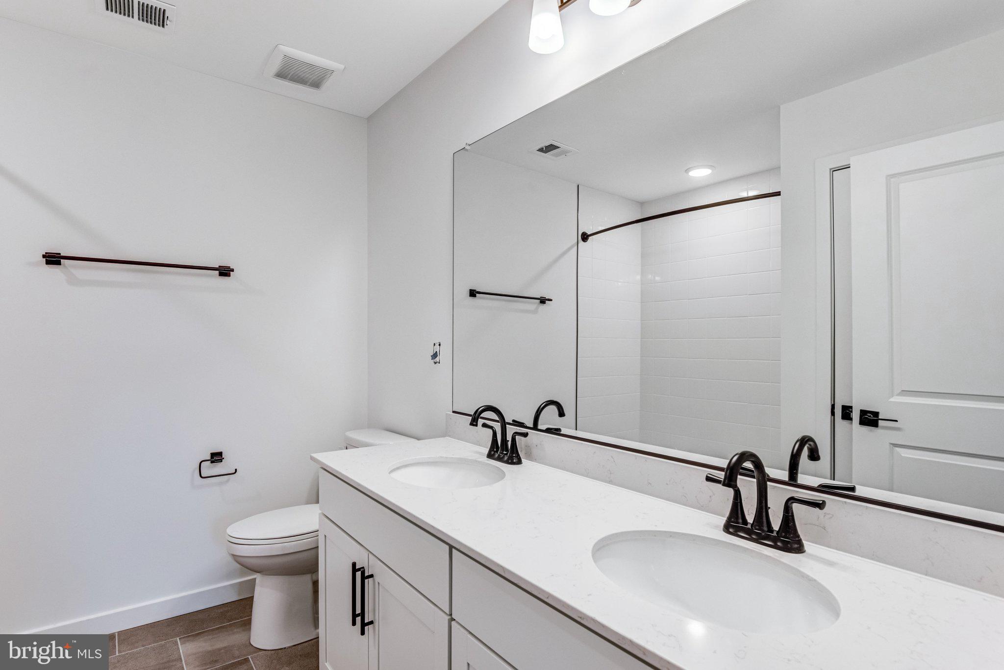 2071 Springvale Drive Bealeton, VA 22712 - Photo 29 of 64 a bathroom with a sink and a mirror