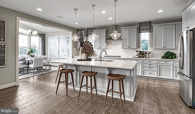 a large kitchen with a table and chairs