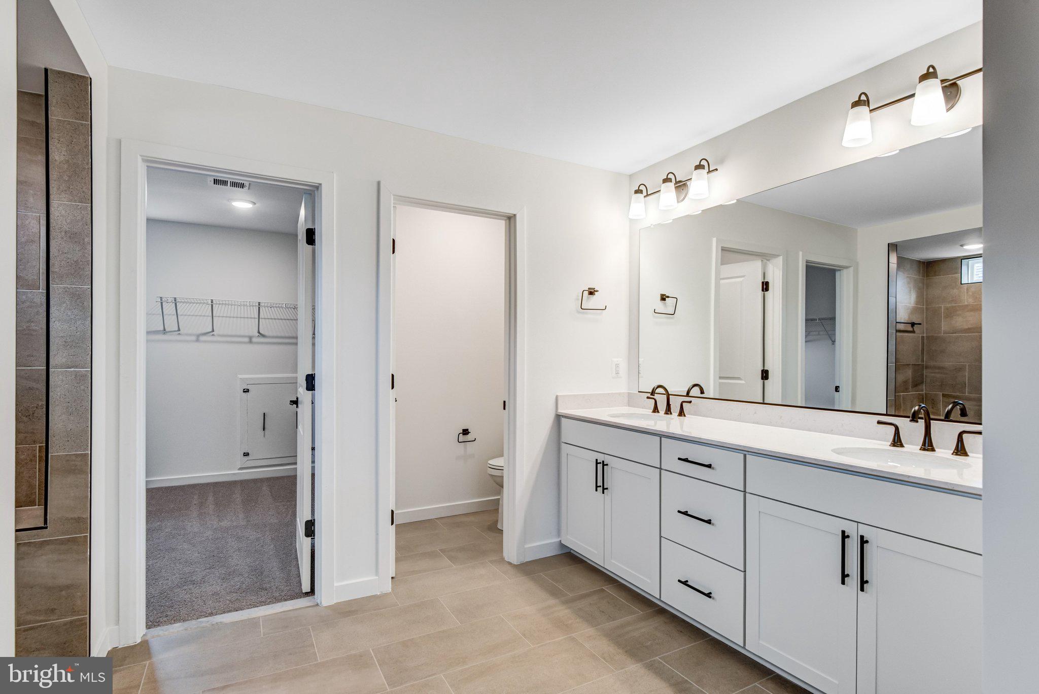 2071 Springvale Drive Bealeton, VA 22712 - Photo 37 of 64 a bathroom with a double vanity sink mirror and double