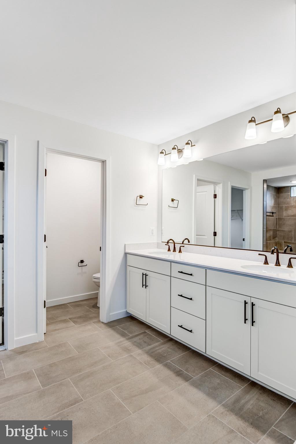 2071 Springvale Drive Bealeton, VA 22712 - Photo 38 of 64 a spacious bathroom with a granite countertop sink mirror and a