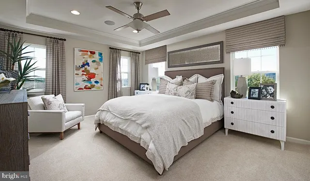 a spacious bedroom with a large bed and a chandelier