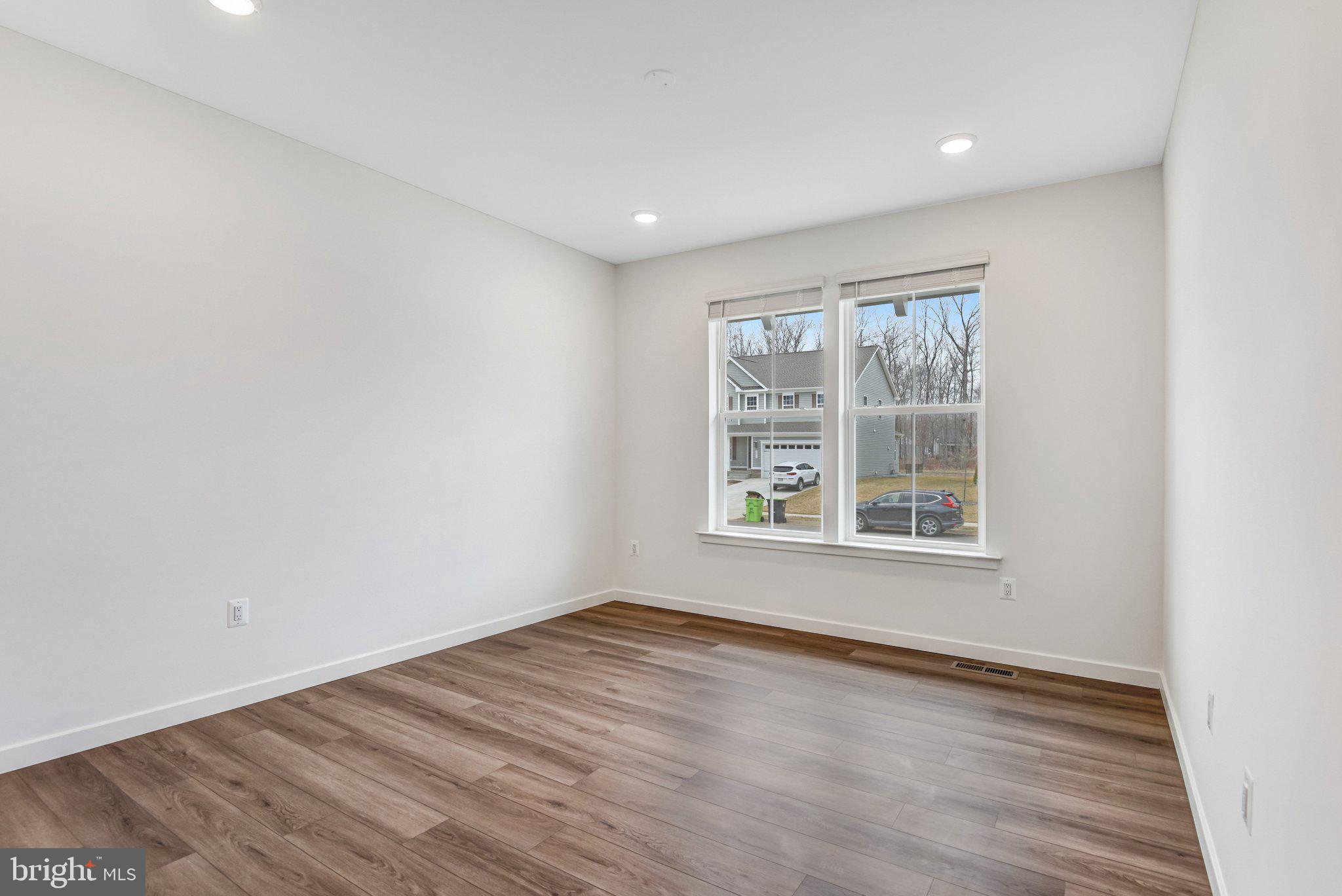 2071 Springvale Drive Bealeton, VA 22712 - Photo 10 of 64 an empty room with wooden floor and windows