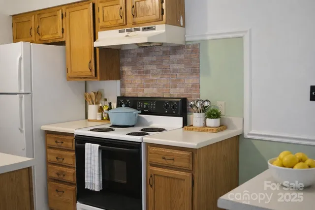 a kitchen with a sink a stove and refrigerator