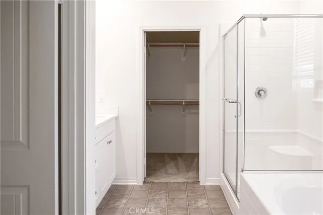 a view of bathroom with a shower and a sink