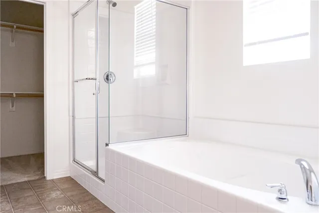 a bathroom with a bathtub and shower