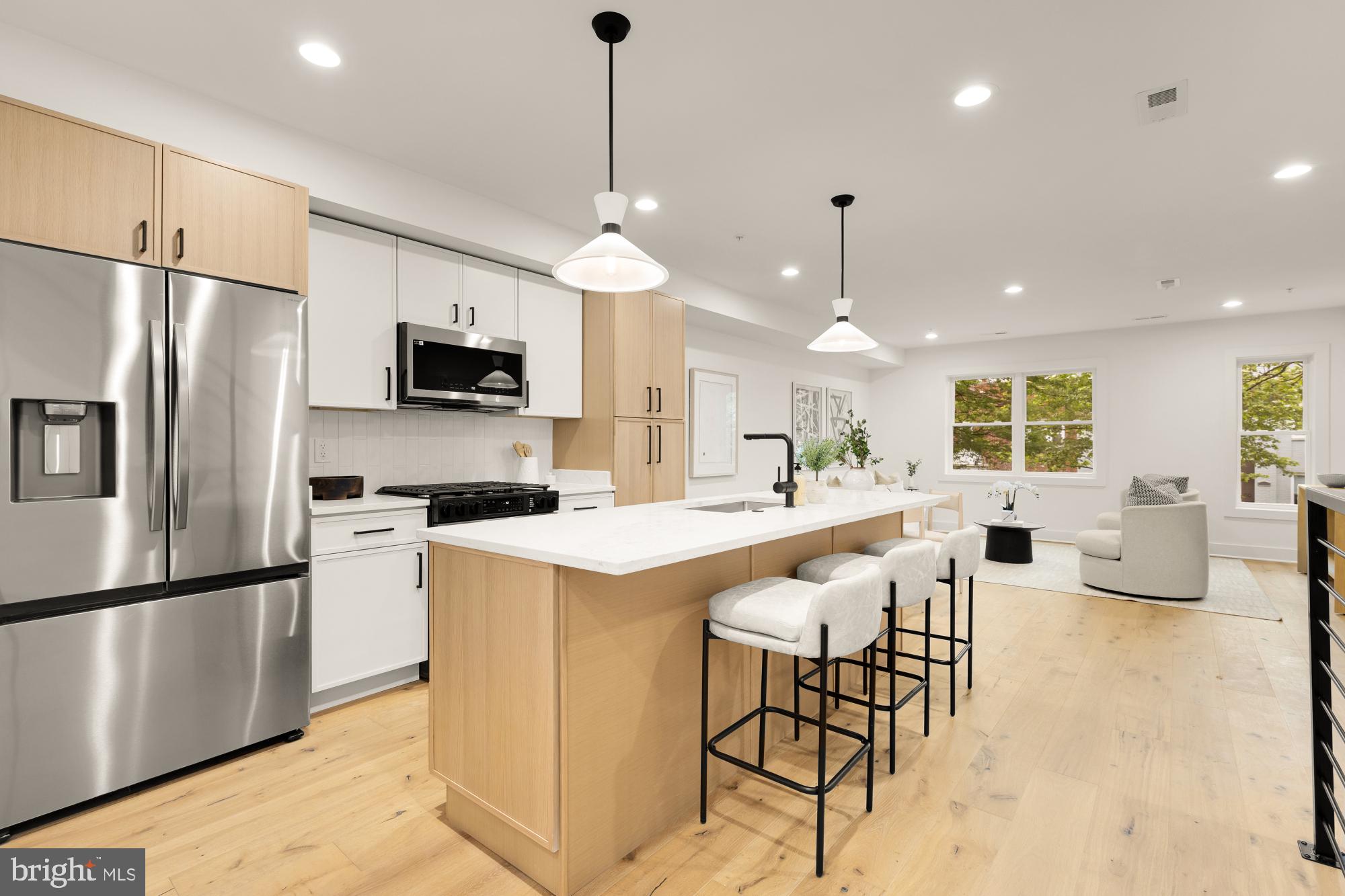 1325 Orren Street Northeast, Unit D Washington, DC 20002 - Photo 11 of 44 a kitchen with stainless steel appliances kitchen island a refrigerator and a stove top oven