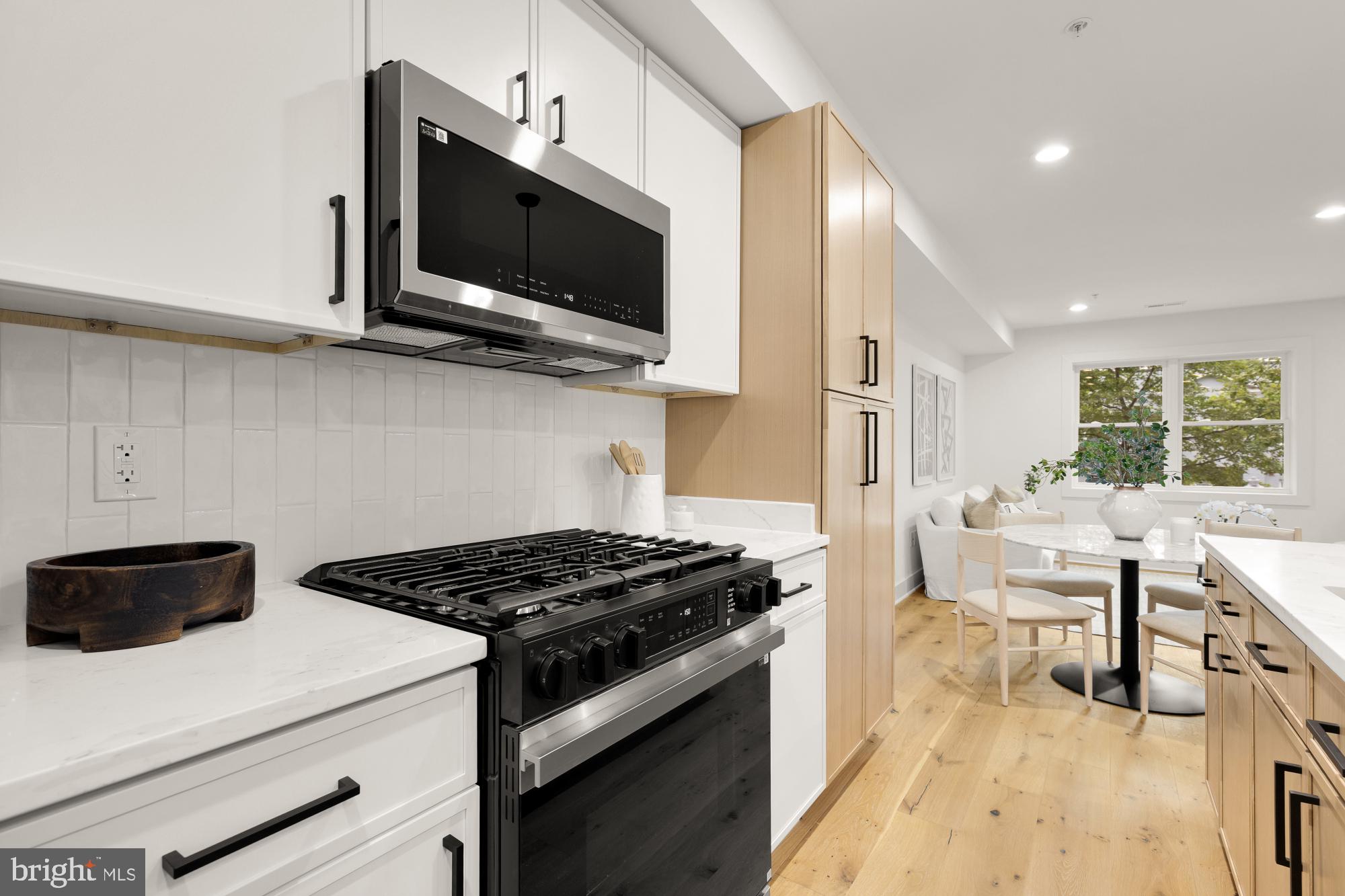 1325 Orren Street Northeast, Unit D Washington, DC 20002 - Photo 15 of 44 a kitchen with a stove and a microwave