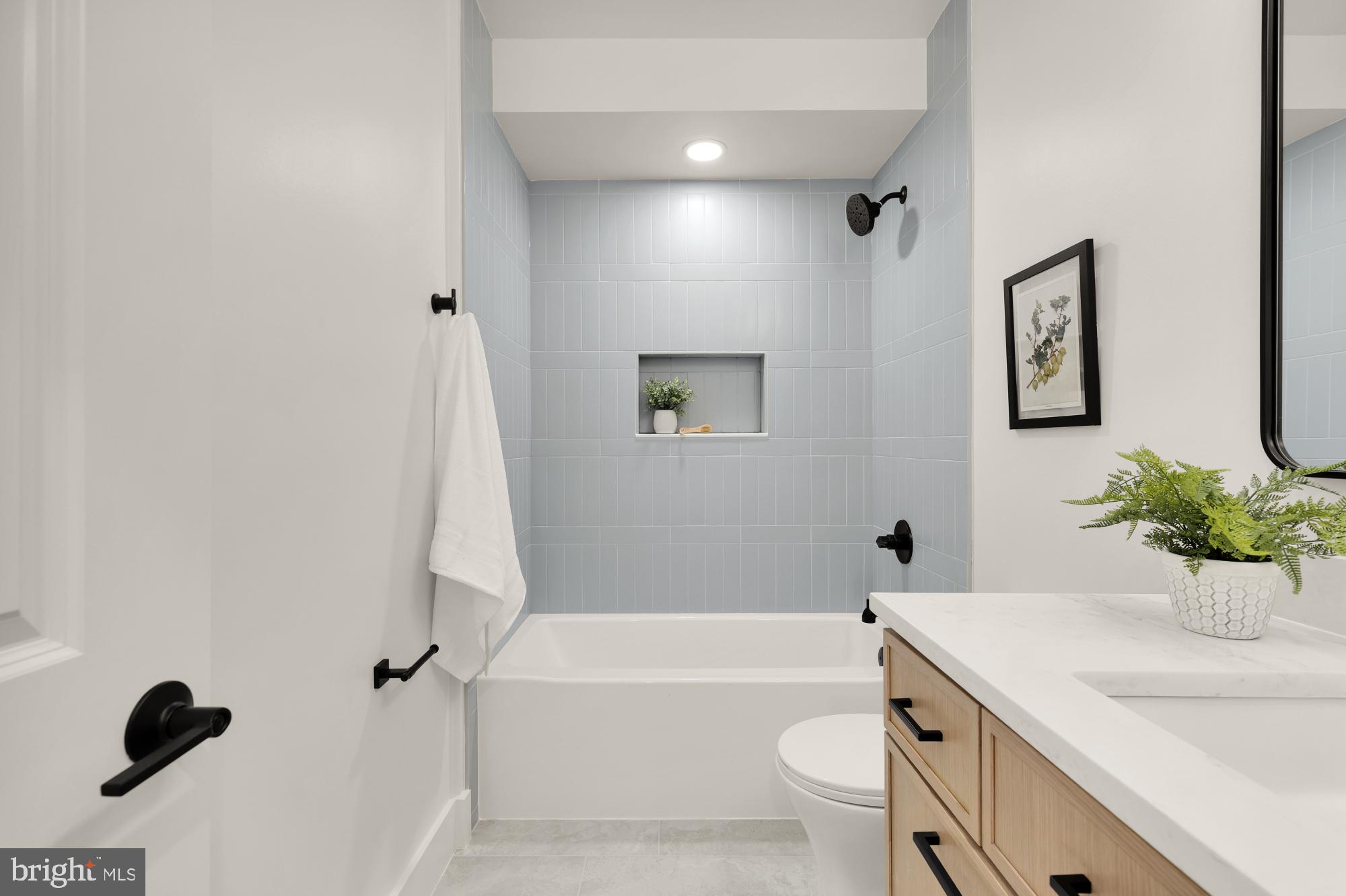 1325 Orren Street Northeast, Unit D Washington, DC 20002 - Photo 17 of 44 a bathroom with a sink a toilet and shower