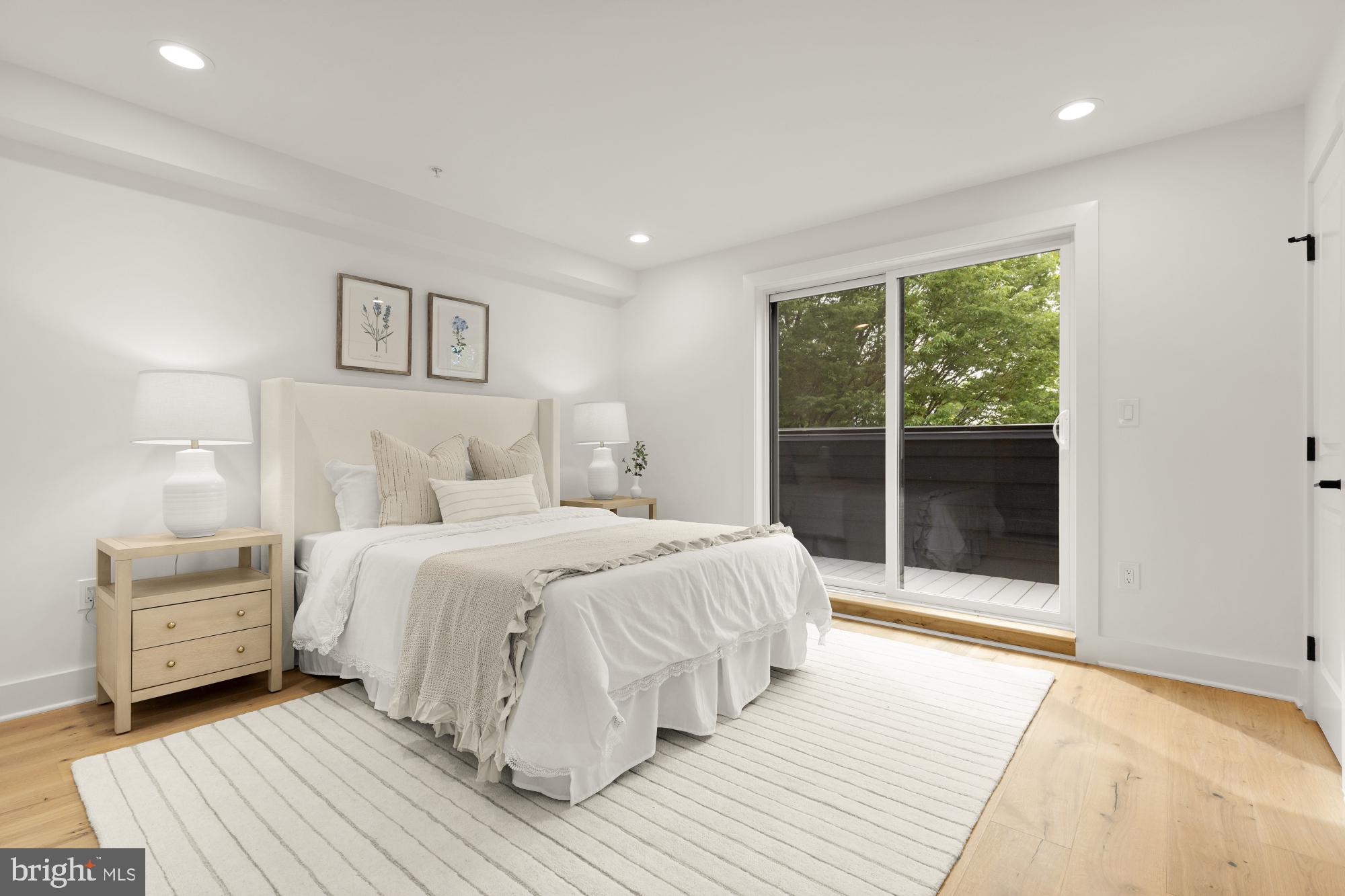 1325 Orren Street Northeast, Unit D Washington, DC 20002 - Photo 19 of 44 a bedroom with a large bed and a large window