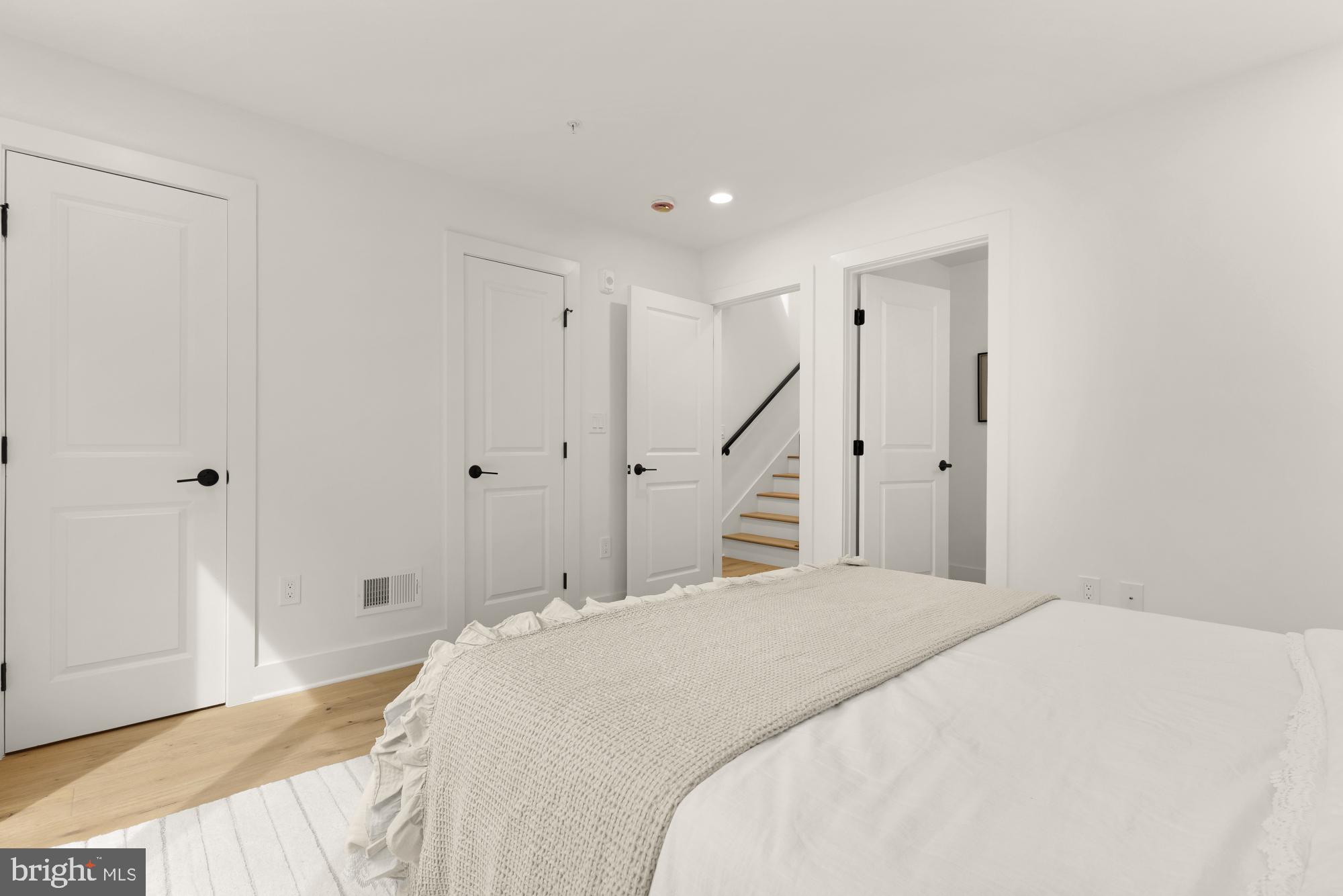 1325 Orren Street Northeast, Unit D Washington, DC 20002 - Photo 22 of 44 a bedroom with a large bed and a chandelier