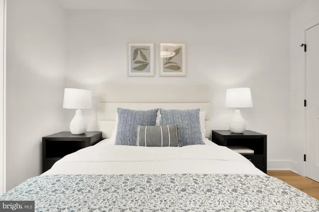 a bedroom with a bed and a lamp on table