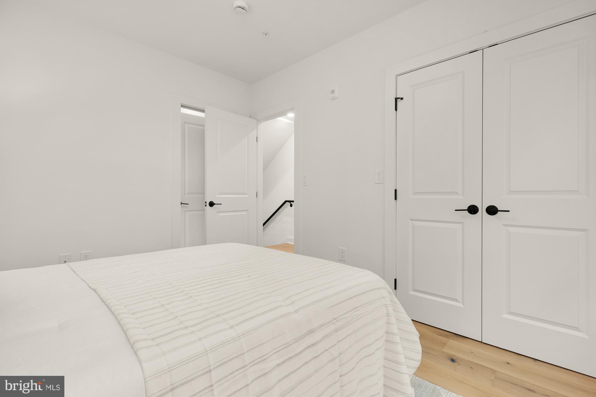 1325 Orren Street Northeast, Unit D Washington, DC 20002 - Photo 32 of 44 a large white bed in a white room