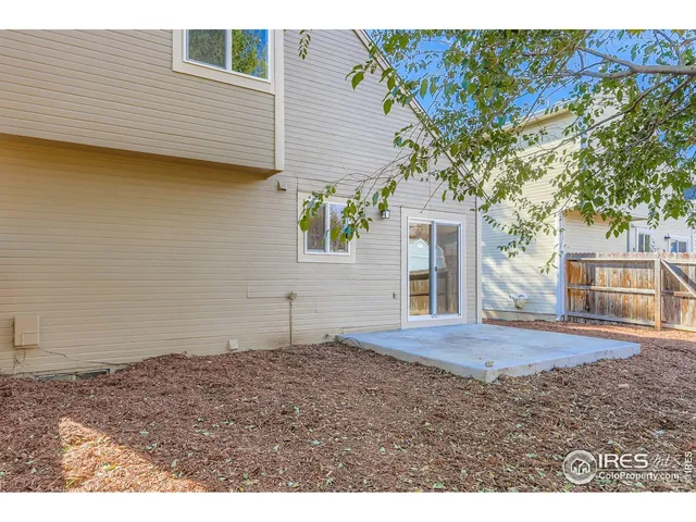 a view of a backyard with large trees