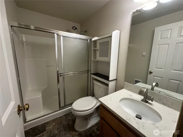 a bathroom with a sink toilet and shower