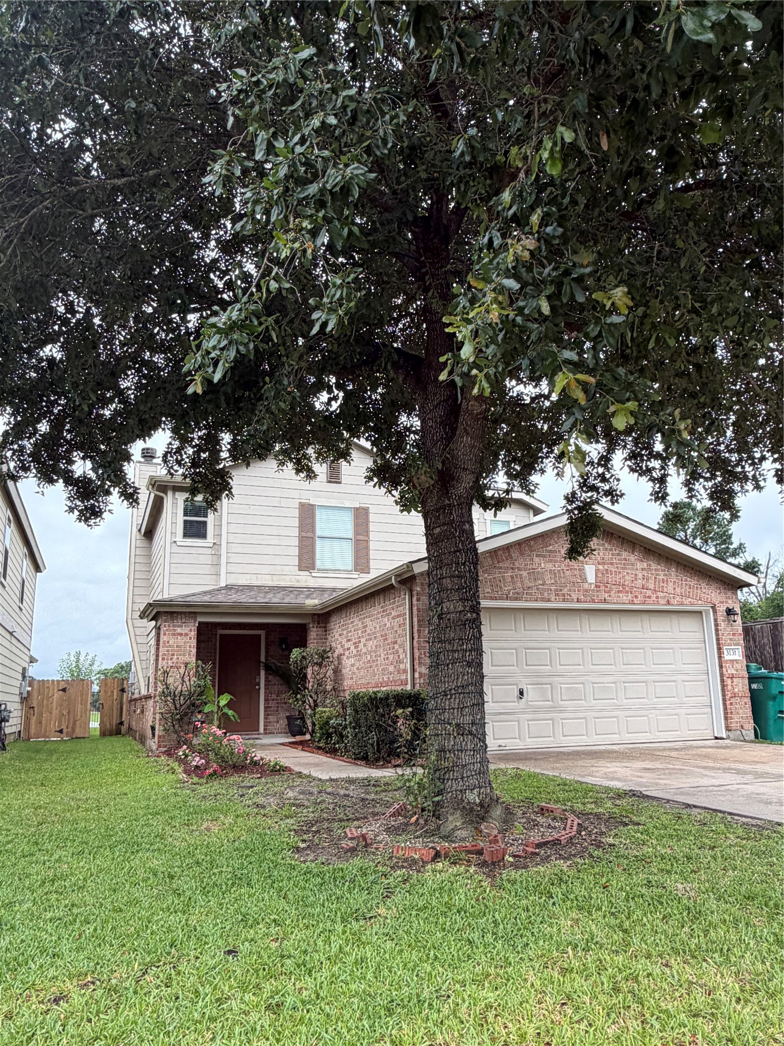 3131 Peachstone Place Spring, TX 77389 - Photo 3 of 20 a front view of a house with a garden and tree