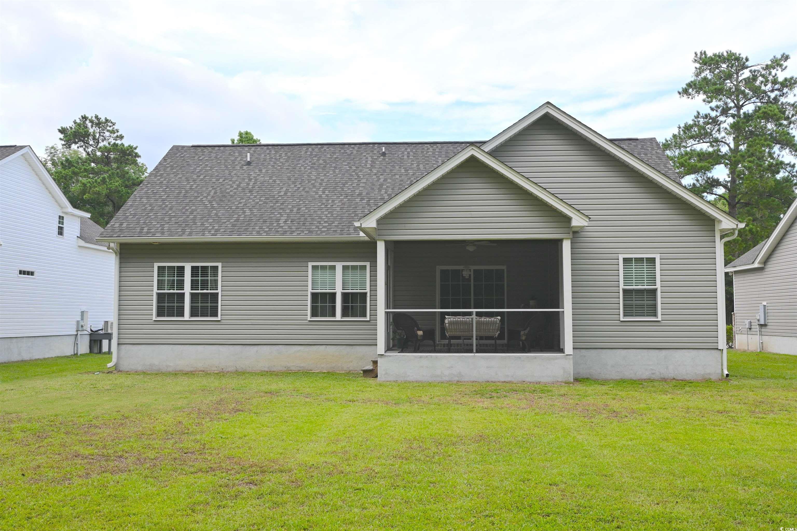 523 Charlton Boulevard Georgetown, SC 29440 - Photo 25 of 33 Rear view of property featuring a yard, a screened porch, and a shingled roof