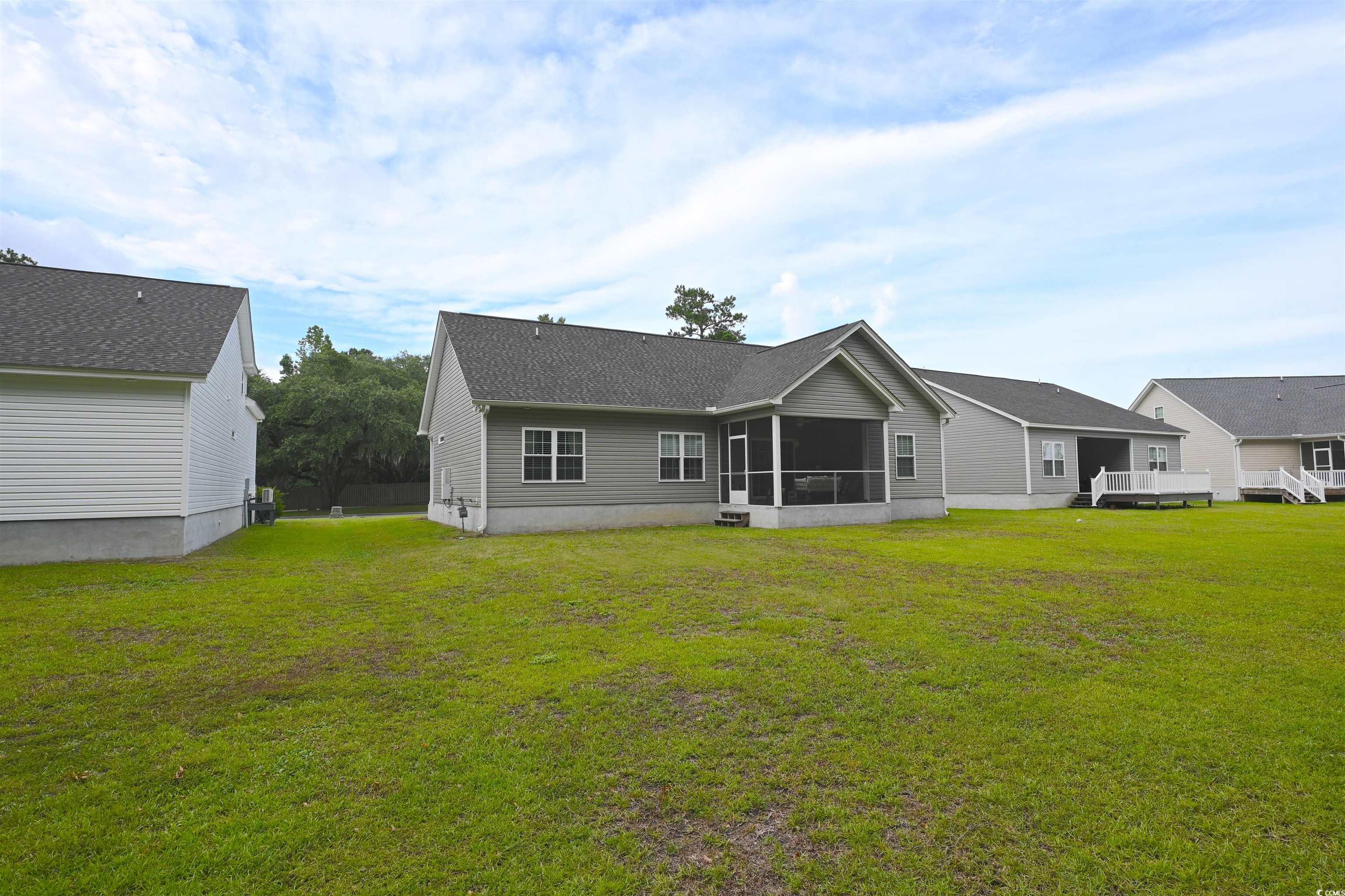 523 Charlton Boulevard Georgetown, SC 29440 - Photo 26 of 33 Back of property with a screened porch and a lawn