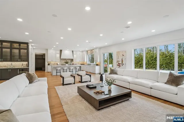 a living room with furniture rug and a large window