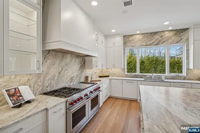 a kitchen with a stove a sink and a refrigerator