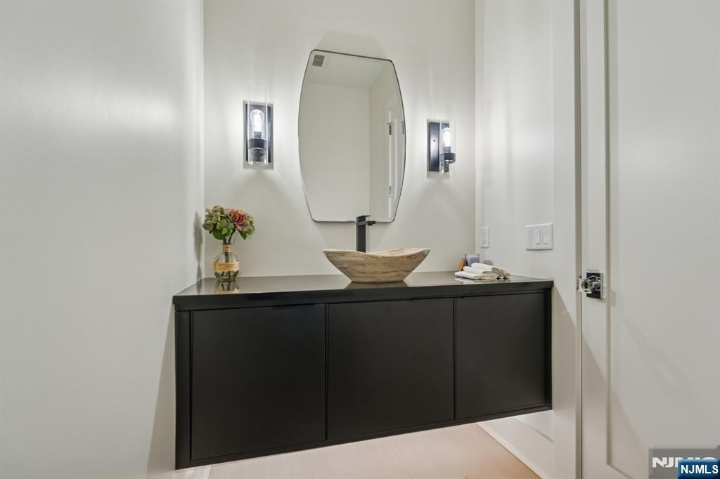 50 Roberts Road Englewood Cliffs, NJ 07632 - Photo 20 of 50 a bathroom with a sink vanity and mirror