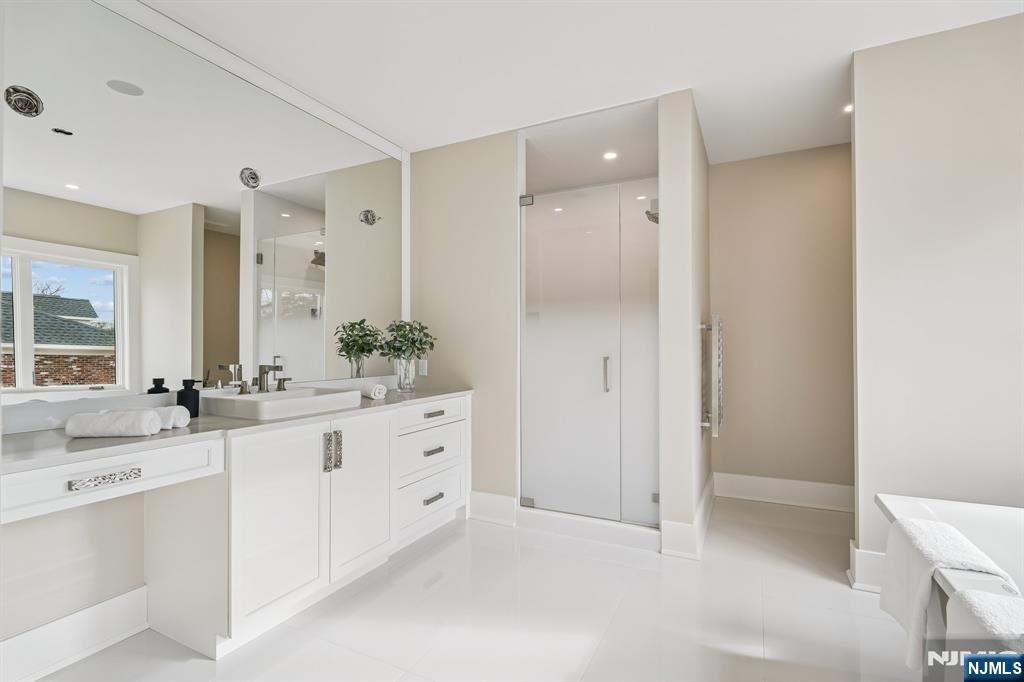 50 Roberts Road Englewood Cliffs, NJ 07632 - Photo 27 of 50 a bathroom with a granite countertop sink a mirror and a