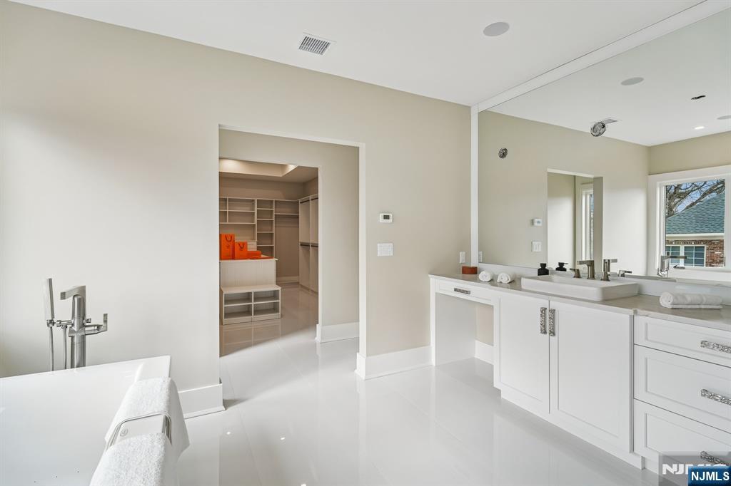 50 Roberts Road Englewood Cliffs, NJ 07632 - Photo 28 of 50 a large bathroom with a sink and a mirror