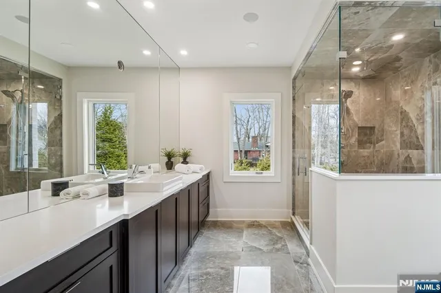 a bathroom with a double vanity sink and a mirror