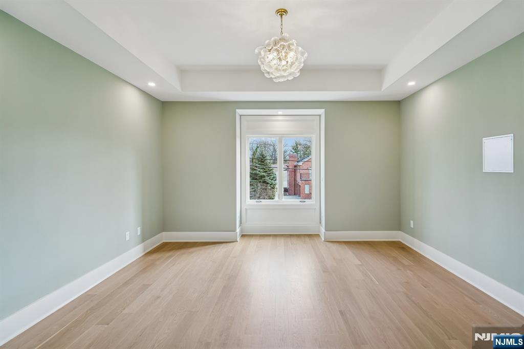 50 Roberts Road Englewood Cliffs, NJ 07632 - Photo 33 of 50 an empty room with wooden floor and windows