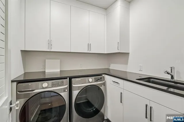 a view of storage and utility room with washer and dryer