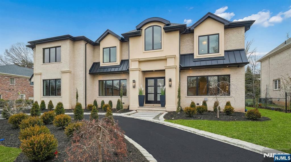 50 Roberts Road Englewood Cliffs, NJ 07632 - Photo 50 of 50 a front view of a house with garden
