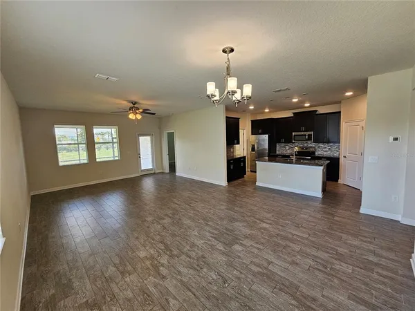 a view of a livingroom with a kitchen