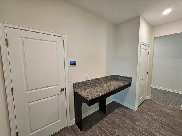 a room with a table and wooden floor