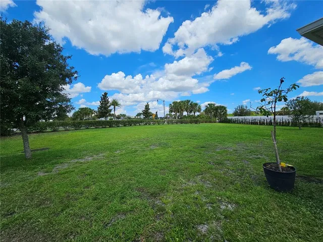 a view of a garden with a building in the background