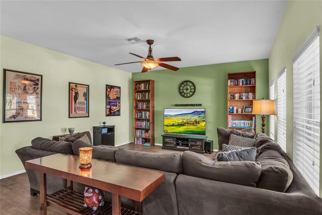 2962 Inca Avenue Clermont, FL 34715 - Photo 18 of 55 a living room with furniture a large window and a flat screen tv