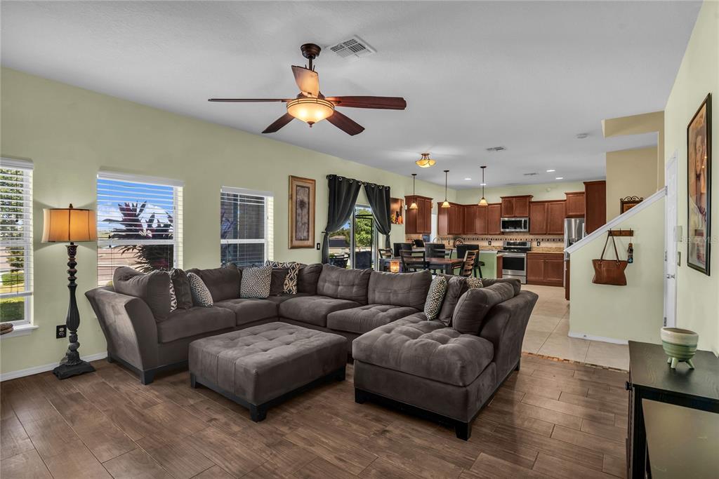 2962 Inca Avenue Clermont, FL 34715 - Photo 19 of 55 a living room with furniture kitchen view and a chandelier