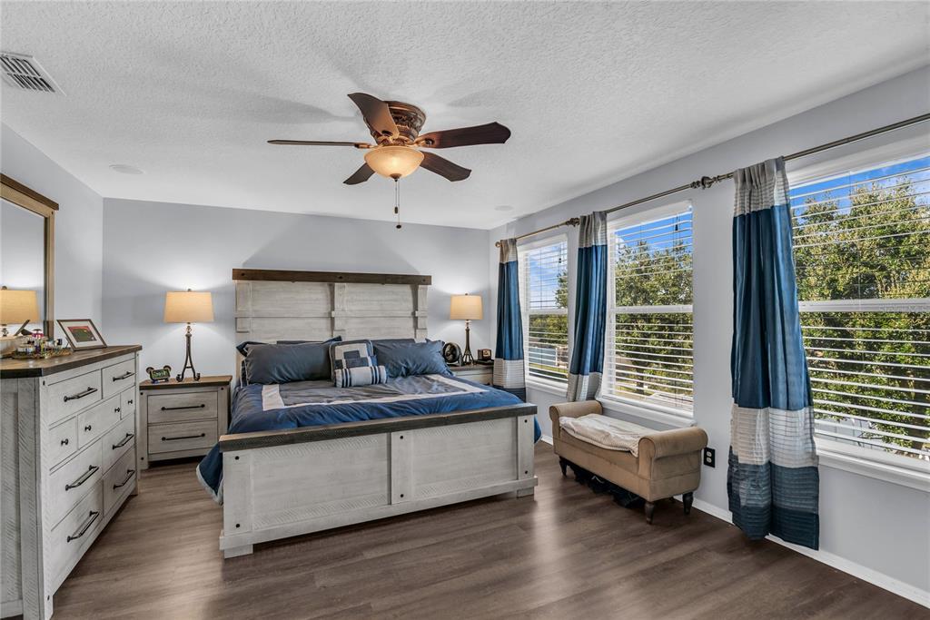 2962 Inca Avenue Clermont, FL 34715 - Photo 25 of 55 a bedroom with a bed and wooden floor