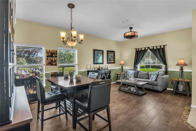 a living room with furniture a ceiling fan and a window