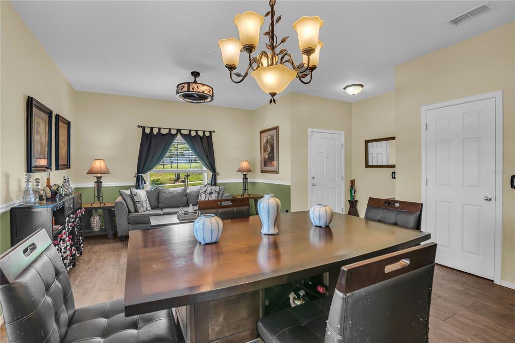 2962 Inca Avenue Clermont, FL 34715 - Photo 10 of 55 a view of a dining room with furniture and wooden floor
