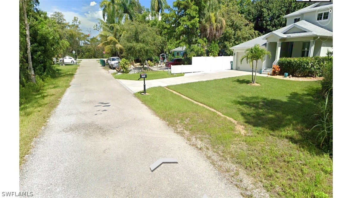 Pine Tree Drive Naples, FL 34112 - Photo 4 of 7 a view of a house with a yard and potted plants