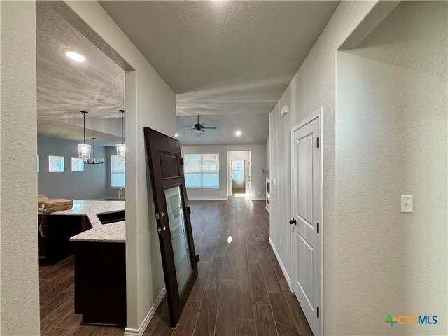 a view of a hallway view with wooden floor and staircase