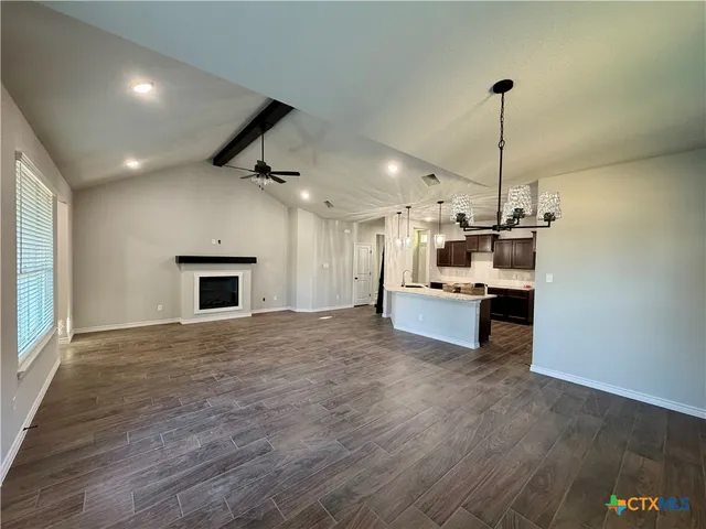 a view of a kitchen with a sink and a stove top oven